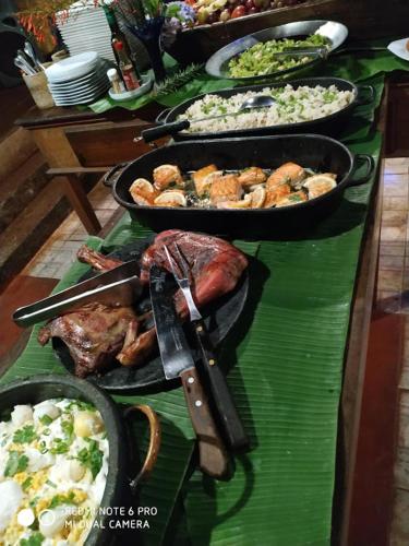 a table with many different types of food on it at Capricho Asturiano in Santo Antônio do Leite