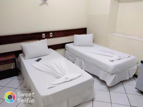 Una cama o camas en una habitación de Hotel Central Rosário