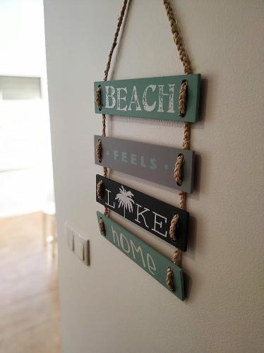 a group of signs hanging on a wall at BonitaBay in São Martinho do Porto