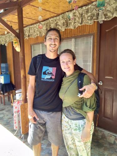 a man and a woman standing in front of a house at Darpins Guesthouse in Dauin