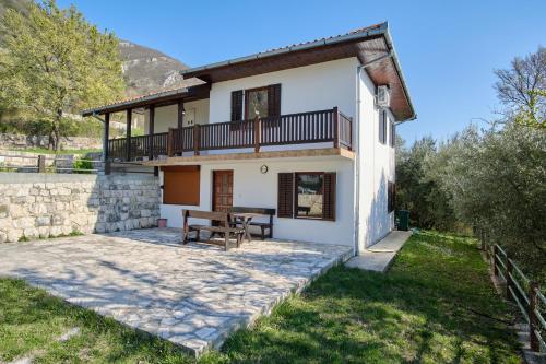an external view of a villa with a table and a balcony at Villa Olga in Radanovići