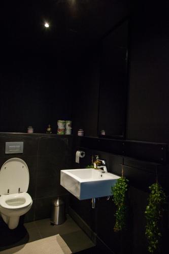 a bathroom with a white sink and a toilet at Wex 1 Apartments in Cape Town