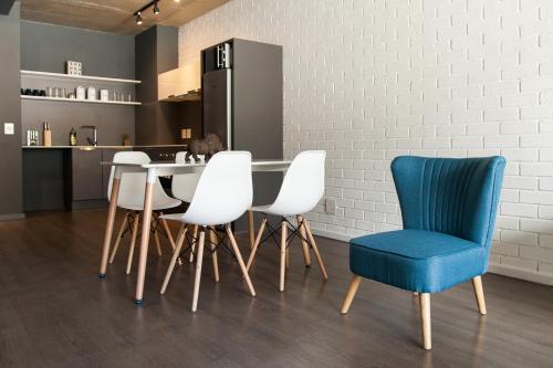 a kitchen with a table and four chairs at Wex 1 Apartments in Cape Town
