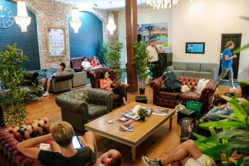 a group of people sitting in a living room at Nomads Sydney in Sydney