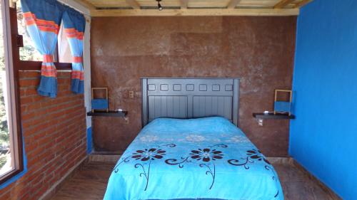 ZIRAHUÉN CUIN Habitaciones Rústicasにあるベッド