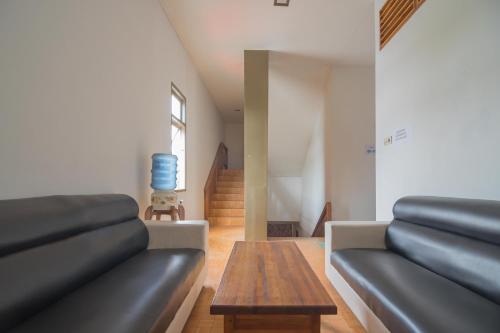 a living room with a couch and a table at RedDoorz near Gajah Mada Pontianak in Pontianak