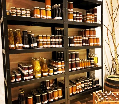 a shelf filled with lots of bottles of honey at moser-HOCHKÖNIG Genuss Wirtshaus Hotel in Maria Alm am Steinernen Meer