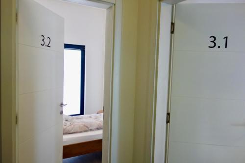 a room with a mirror and a door with a window at Hotel Seeadler in Friedrichshafen
