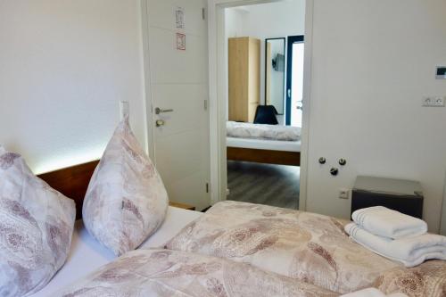 a bedroom with a bed with pillows on it at Hotel Seeadler in Friedrichshafen