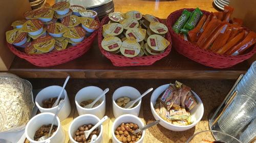 a table with baskets of food and bowls of nuts at Schillers Hotel & Café - GARNI - in Lüdenscheid