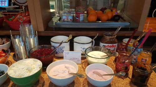 a counter topped with bowls of food and other ingredients at Schillers Hotel & Café - GARNI - in Lüdenscheid