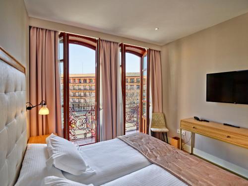 Postel nebo postele na pokoji v ubytování Hotel Boutique ADOLFO