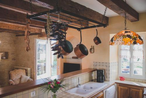 a kitchen with a sink and some pots and pans at La ferme de Bousserand in Pontours