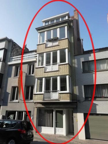 a building with a red circle in front of it at Arno's Place in Ostend