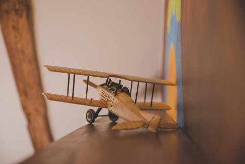 a small toy airplane sitting on top of a shelf at La ferme de Bousserand in Pontours