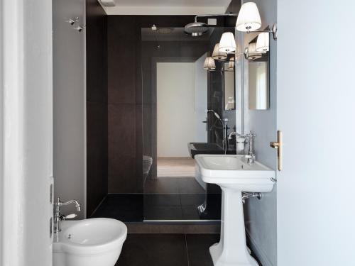 a bathroom with a white sink and a toilet at B&B Stupido Hotel in Florence