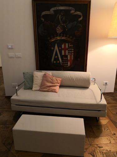 a couch with two pillows on it in a room at Cupola Rubatti Tornaforte: Apollo e le sue Muse in Cuneo