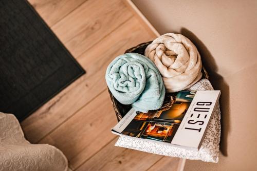 a box with two blankets and a book at Il Bosco apartment in Arco