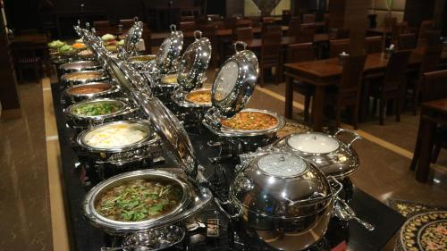 a buffet of food on a table in a restaurant at Aiyaree Place Hotel SHA PLUS in Jomtien Beach