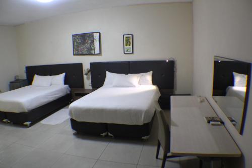Cama o camas de una habitación en Murex Plaza Hotel & Suites