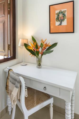 a white desk with a vase of flowers on it at Villa Abiman in Dickwella