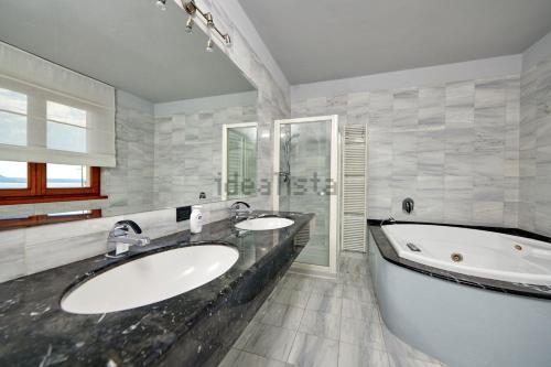 a bathroom with two sinks and a large tub at Villa Anna in Brenzone sul Garda