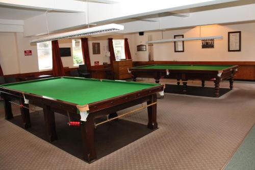 two pool tables in a room with green cloth at Ravenswood Social Club in Banchory