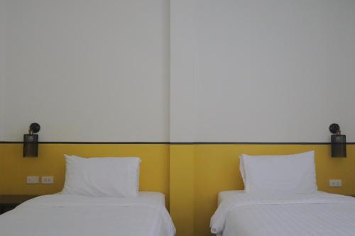 two beds sitting next to each other in a room at Goodnight Poshtel + Free Netflix in Hat Yai