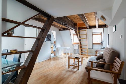 un salon avec un escalier et un canapé dans l'établissement CityCosy Strasbourg - Budget St Thomas Serruriers, à Strasbourg