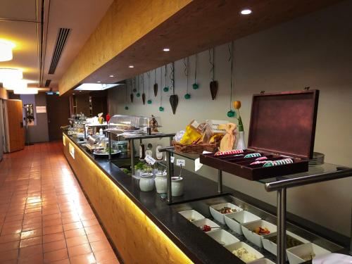 a buffet line in a restaurant with food at Hotel-Gasthof Löwen in Feldkirch