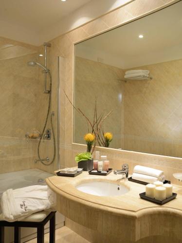 a bathroom with a sink and a shower and a mirror at Colonna Palace Hotel in Rome
