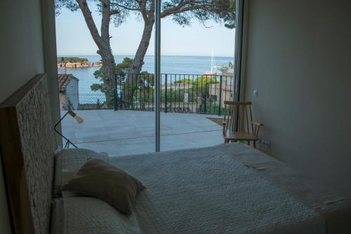 a bedroom with a bed and a view of the ocean at VILLA GALI in Sant Feliu de Guíxols