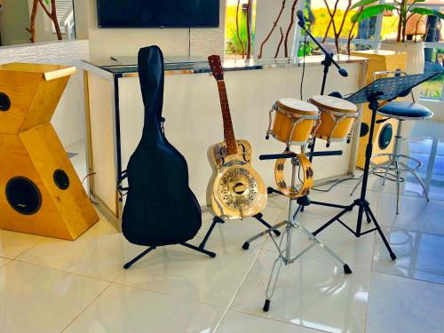 a guitar and other musical instruments in a room at ROCCA Del GARDA Residences in Binangonan