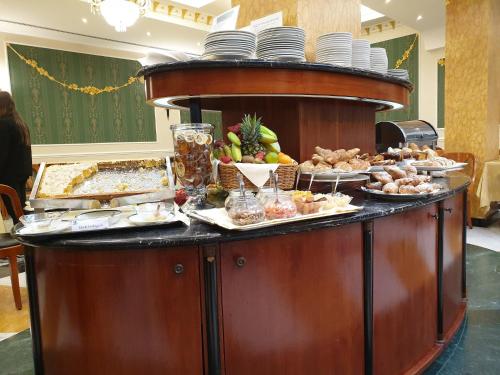 a buffet with many different types of food on a table at Zanhotel Europa in Bologna