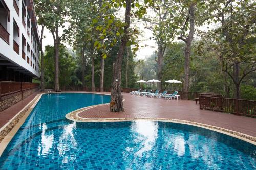a swimming pool with a statue in front of a building at The Imperial Mae Hong Son Resort in Mae Hong Son