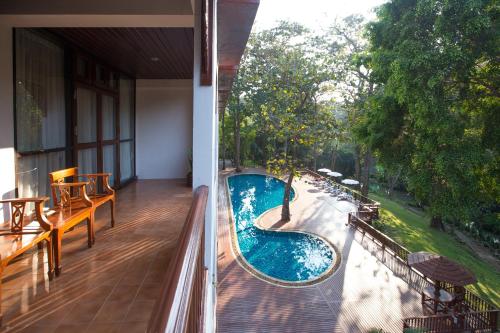 a balcony with a swimming pool on a house at The Imperial Mae Hong Son Resort in Mae Hong Son