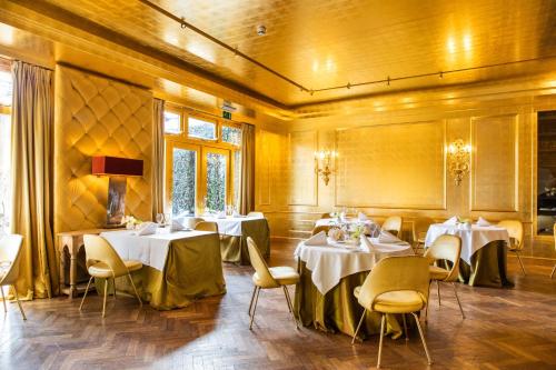 a dining room with white tables and chairs at Restaurant Hotel Merlet in Schoorl