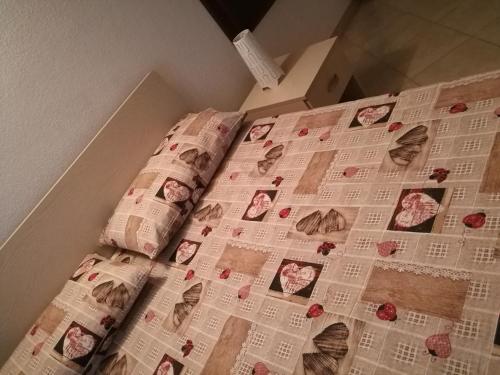 a bed with a bunch of newspapers on it at Appartamento" Le Bourg 61" VDA CIR 0208 in Aosta
