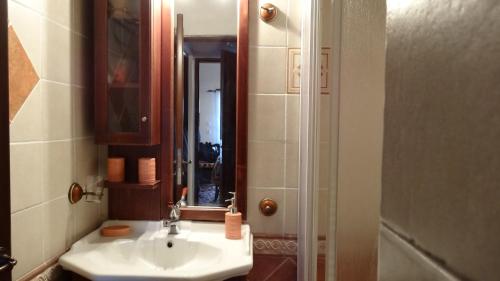 a bathroom with a sink and a mirror at Filia House - Kalavryta in Klitoria