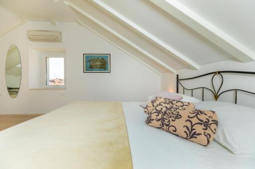 a white bedroom with a bed and a window at Hedera Estate, Hedera A19 in Dubrovnik
