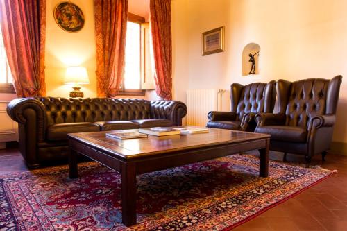a living room with leather couches and a coffee table at Art Hotel Villa Agape - Place of Charme in Florence