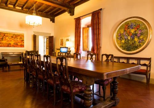 a dining room with a large wooden table and chairs at Art Hotel Villa Agape - Place of Charme in Florence