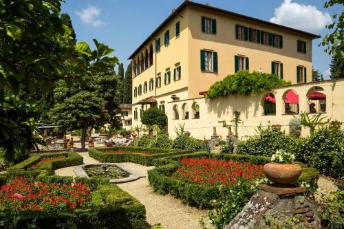a building with a garden with flowers in front of it at Art Hotel Villa Agape - Place of Charme in Florence