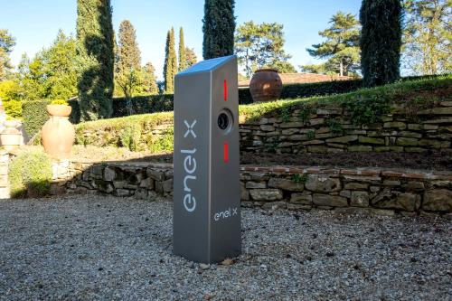 a sign in front of a stone wall at Art Hotel Villa Agape - Place of Charme in Florence