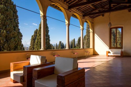 a large room with white chairs and windows at Art Hotel Villa Agape - Place of Charme in Florence