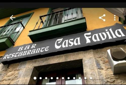 a building with a sign on the side of it at Casa Favila in Potes