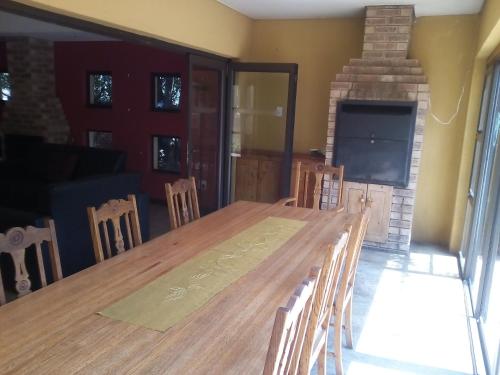 a dining room with a table and chairs and a fireplace at Woodpecker Guesthouse Middelburg Mpumalanga in Middelburg