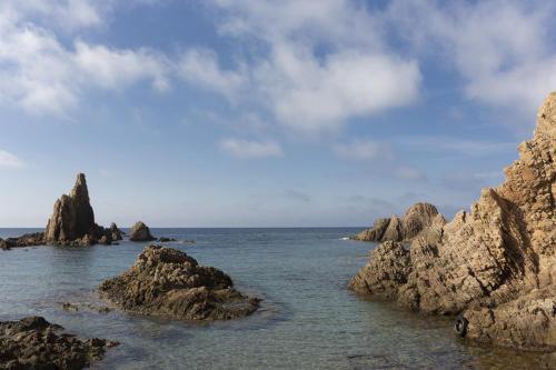 a view of the ocean with rocks in the water at Hotel Costasol in Almería