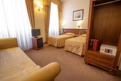 a hotel room with two beds and a mirror at Hosianum Palace in Rome