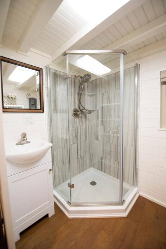 a bathroom with a shower and a sink at Montana Escape Elegant Tiny House in Waco Near Magnolia in Waco